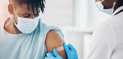 Buy stock photo Doctor, man and plaster for vaccine injection at clinic, face mask and prevent cold in pandemic. Patient, nurse and helping in hospital for protection, healthcare and bandage for wound or injury