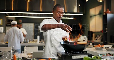 Buy stock photo Black man, chef and seasoning with frying pan in kitchen at restaurant for fine dining, meal and creativity. Employee, professional and cook with food for culinary, hospitality and catering service