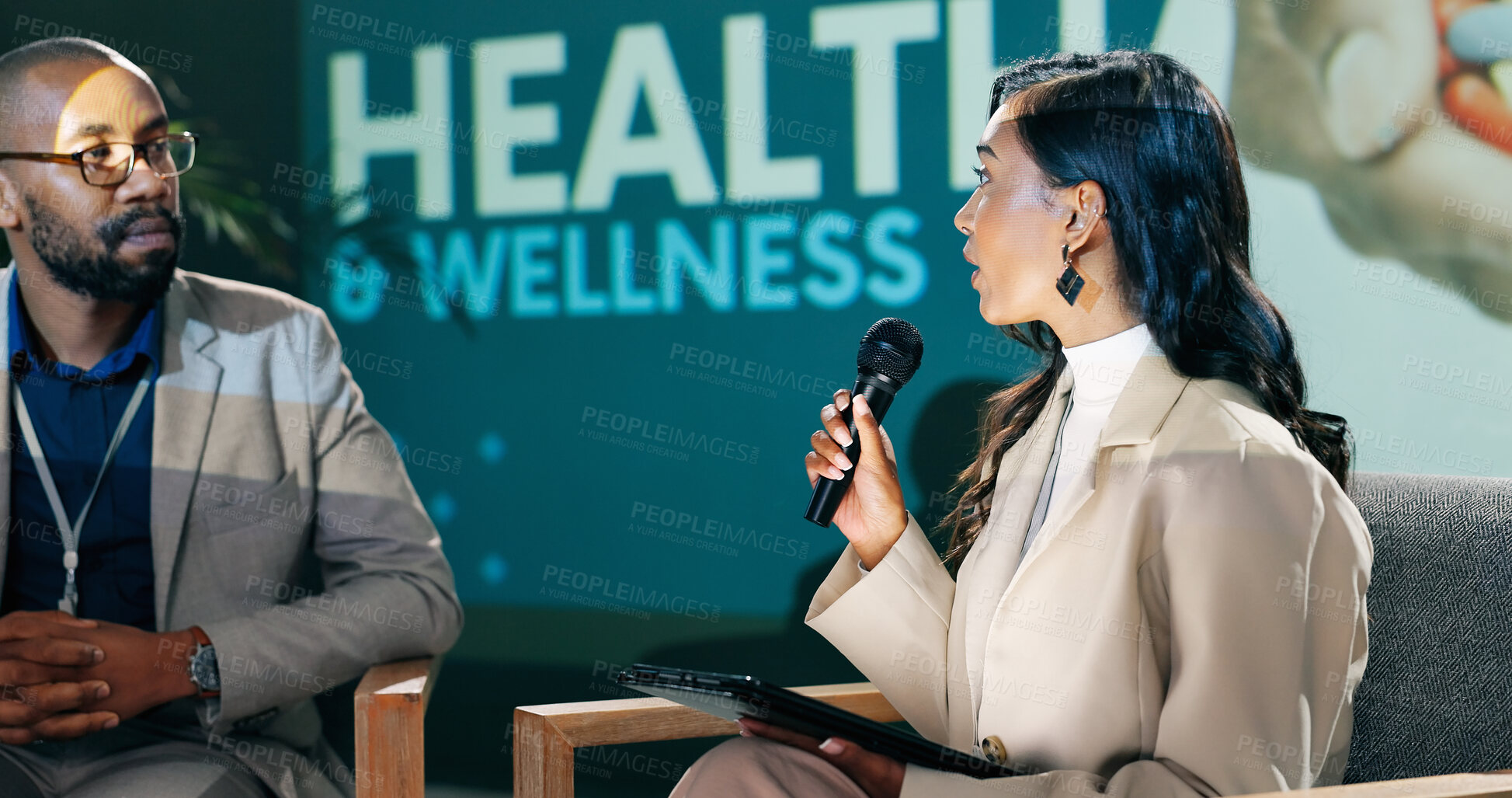 Buy stock photo Speaker, health conference and speech of woman on stage with host on mic and tablet at event. Workshop, talk and seminar presentation on wellness, medicine or medical innovation of drugs with guest