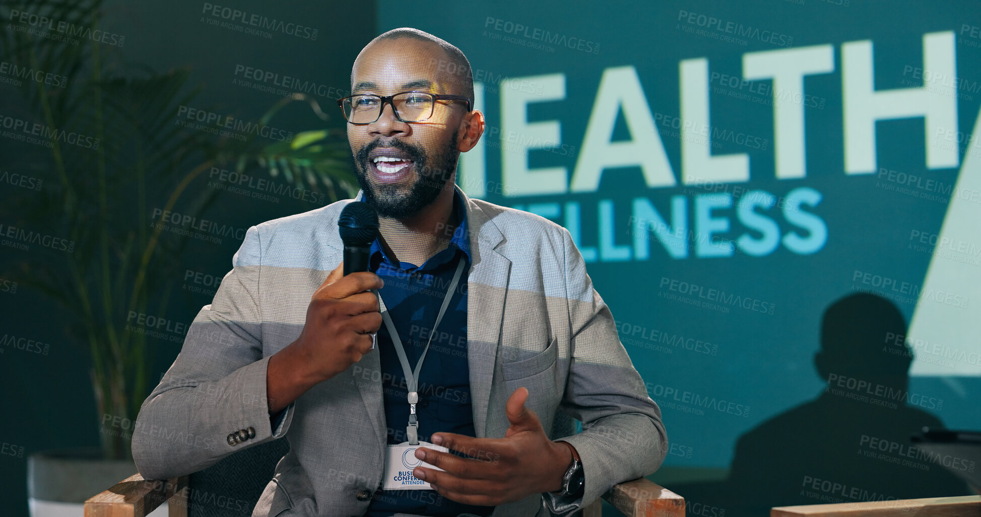 Buy stock photo Speech, seminar and black man on microphone at stage with host or speaker at health event. Workshop, talk and conference presentation on wellness, pharma and medical innovation of drugs at convention