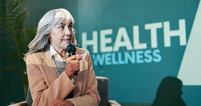Workshop, convention and speech of mature woman on stage with host on mic for health advice or tips. Seminar, talking and conference presentation on wellness, pharma and medical innovation at event