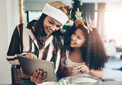 Buy stock photo Family, baking and tablet for christmas cookies, cooking or cake with mother and daughter together while learning online recipe in kitchen, Black woman and child making food to celebrate holiday