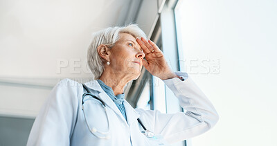 Buy stock photo Senior woman, doctor and headache in burnout, grief or mistake against glass window in hospital building. Frustrated physician, medical healthcare and person in stress, loss or fatigue at clinic