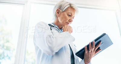 Buy stock photo Healthcare, woman doctor and thinking with tablet for research on medical treatment, cure and reading. Clinic, mature oncologist and digital for report review, solution and planning for diagnosis