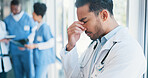 Asian man, doctor and anxiety in burnout, grief or mistake against glass window in hospital building. Frustrated physician, medical healthcare and person in stress, loss or headache at clinic