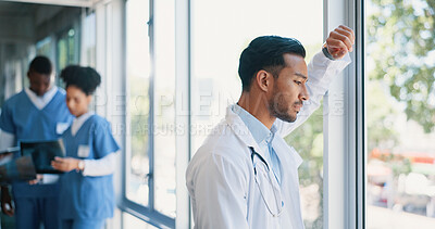 Buy stock photo Asian man, doctor and anxiety in burnout, stress or mistake against glass window in hospital building. Frustrated physician, medical healthcare and person in grief, loss or headache at clinic