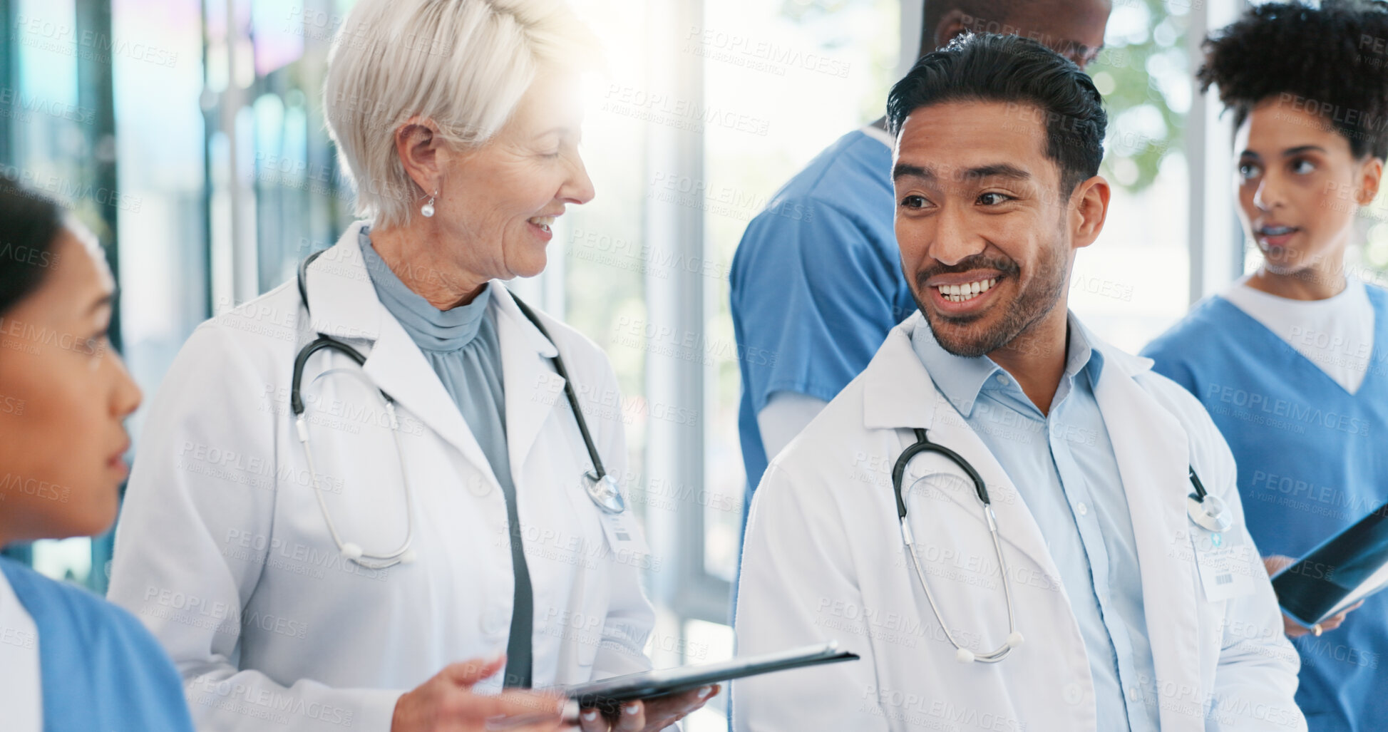 Buy stock photo Teamwork, doctors and meeting with tablet, healthcare and conversation for schedule update in hospital. People, diversity and group with tech, clinic staff and cooperation with planning for surgery