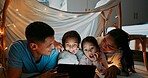 Night, reading and tablet with family in bedroom of home together for bonding, love or storytelling. Education, learning or wow with mother, father and kids on bed in apartment for child development