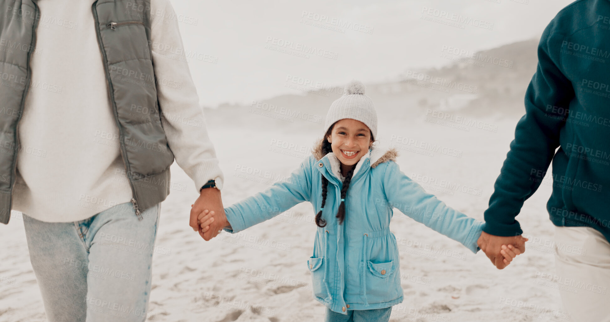 Buy stock photo Family, happy and holding hands at beach together while walking in summer for relax, travel and solidarity. Young girl, smile and support or trust from parents outdoor for bonding, love and childhood