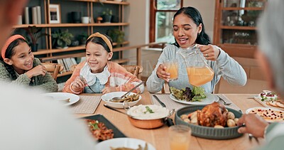 Buy stock photo Juice, dinner and family in dining room for eating together at home with roast meal for nutrition. Happy, bonding and mother pour fruit drink or beverage for kids at supper in house with conversation