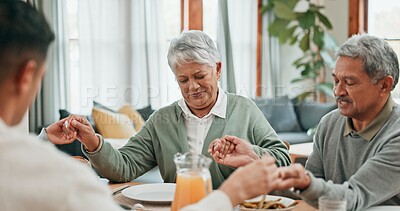 Buy stock photo Family, home and prayer for dinner in table with food for grace, grateful and gratitude. People, respect and holding hands with bonding for love, support and care on thanksgiving gathering or reunion