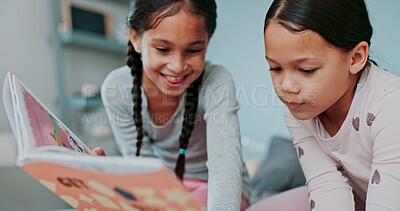 Buy stock photo Girls, kids and happy in bedroom with book for storytelling with bonding, education and child development. Home, sisters and smile with reading fantasy for knowledge, literacy and learning on growth