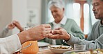 Family, home and pray for dinner in table with food for grace, grateful and gratitude. People, respect and holding hands with bonding for love, support and care on thanksgiving gathering or reunion