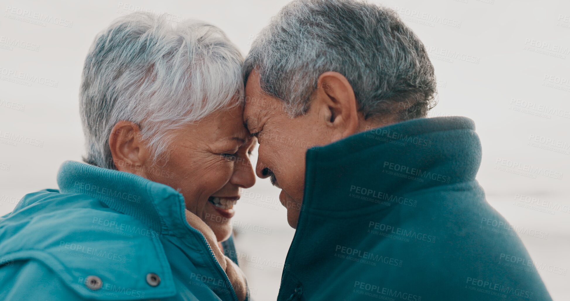 Buy stock photo Forehead, love and senior couple on beach together for holiday bonding, retirement or vacation. Anniversary, romance or smile with elderly man and woman on tropical island coast for peace or travel