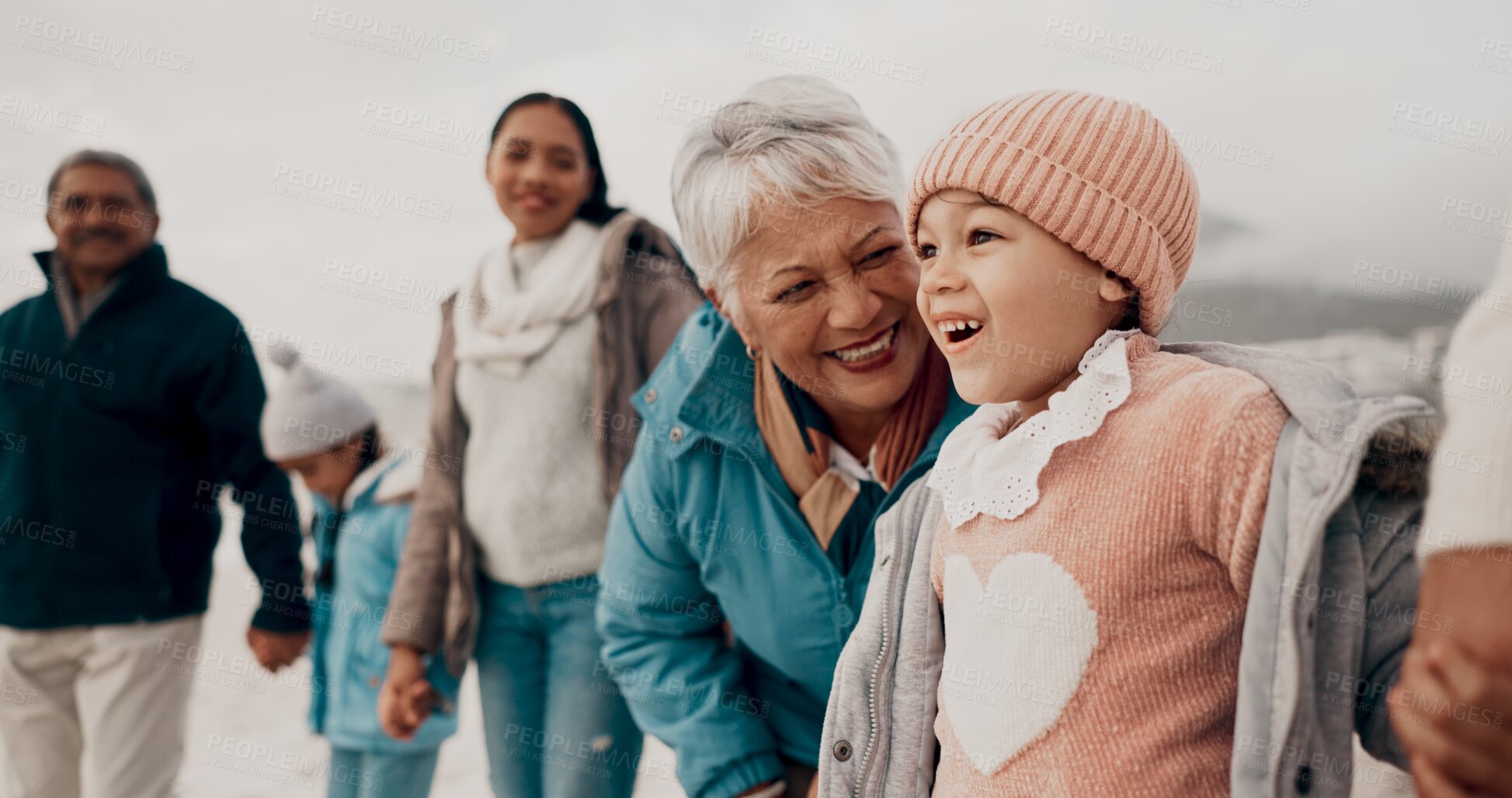 Buy stock photo Grandmother, girl and family at beach with smile, holding hands or outdoor with care, walk and vacation. People, generations and kids with laugh for funny conversation with bonding on winter holiday