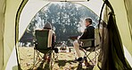 Camping, couple and relax with chair by tent in morning with conversation, bonding and wilderness getaway. Man, woman and together outdoor for weekend adventure, back view and peaceful with comfort.