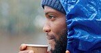 Tea, calm and black man drinking outdoor in winter storm  for hiking, travel and relax in morning. Coffee, peace and freedom in nature for adventure, camping or rain with wildlife watching as tourist