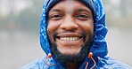 Portrait, black man and rain for travel outdoor on camping adventure, explore and nature journey in morning. African, male person and smile for hiking, freedom and trekking woods for winter vacation