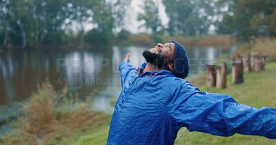 Buy stock photo Black man, enjoy and rain for travel outdoor on camping adventure, explore and nature journey in morning. African, male person and smile for hiking, freedom and trekking woods for winter vacation