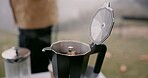 Moka pot, espresso and cup outdoor in winter storm by person for hiking, travel and cozy relax with peace. Hot beverage, coffee and calm in nature for adventure and drink as latte from french press