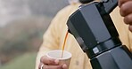 Coffee, machine and pouring in cup outdoor in winter storm as person for hiking, travel and cozy relax. Hot beverage, drink and freedom in nature for adventure and rain as latte from french press