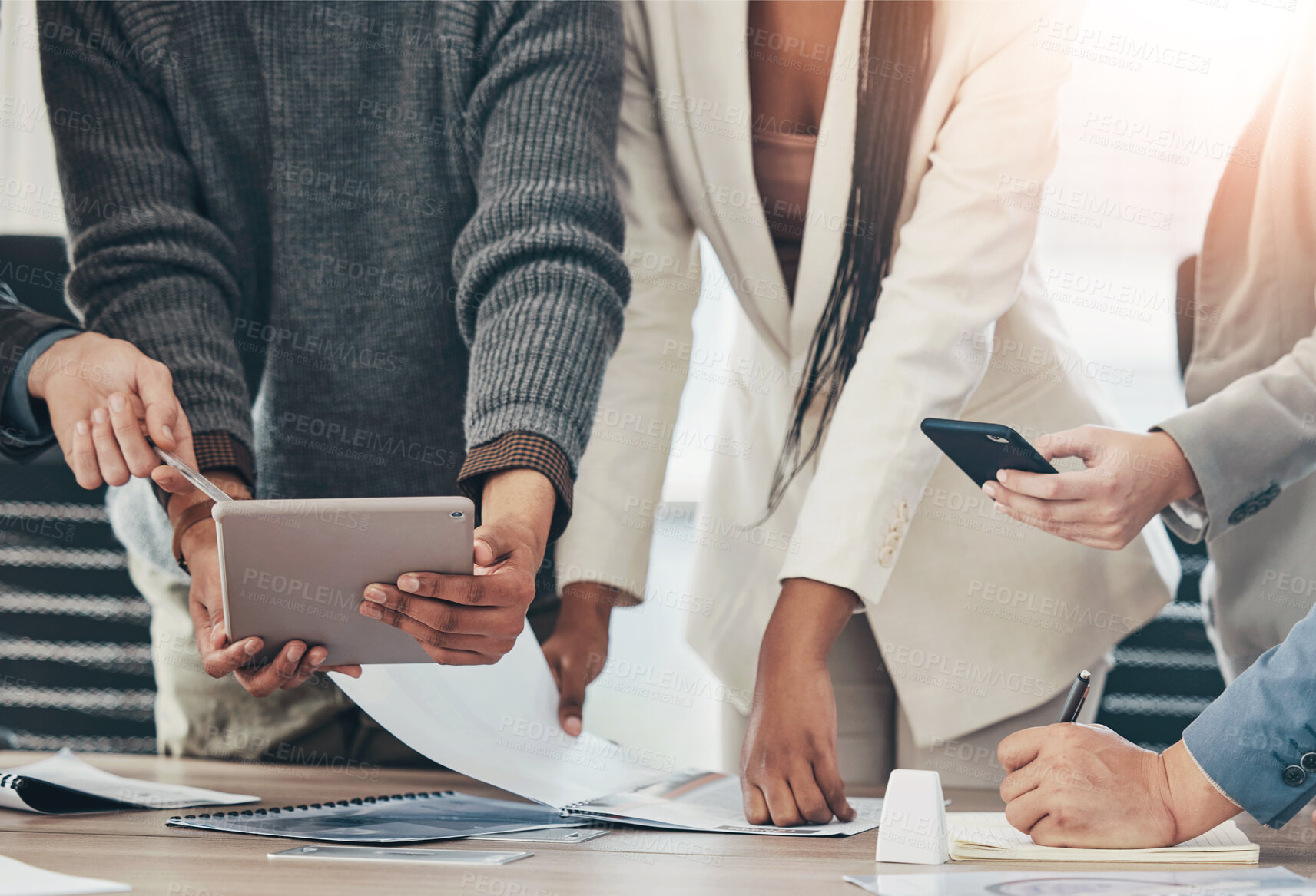 Buy stock photo Shot of a group of unrecognizable businesspeople in a meeting at work