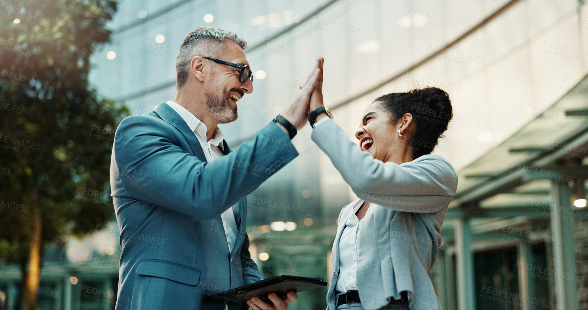 Buy stock photo Man, woman or high five by office building for business with partnership, yes for b2b deal in city. People, together or hand gesture with teamwork or success for digital contract, support for goal