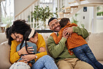 Happy, parents and kids with hug on sofa for appreciation, gratitude and safety in family at home. Mother, father and smile with affection of children in living room for connection, support and love