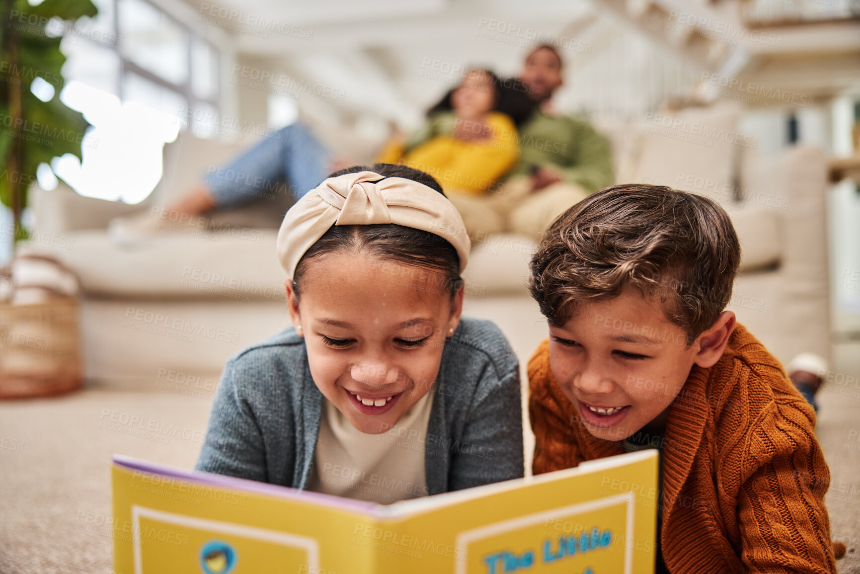 Buy stock photo Home, parents and kids on carpet, book and smile with weekend break, comfort and calm. Reading, family and mother with father, childhood development and education with fun, joy and happiness