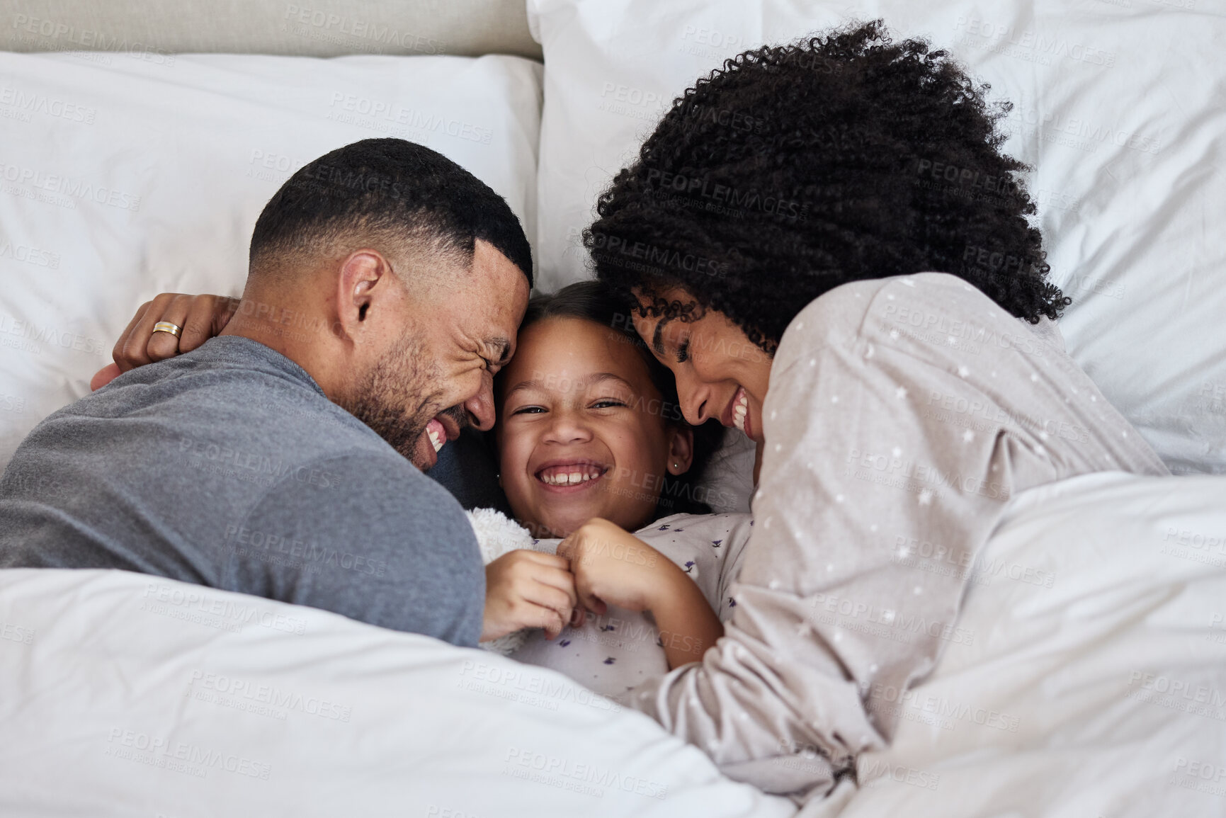 Buy stock photo Mother, dad and girl in bed for happiness, bonding and relax together with care or hug on weekend. Family, love and support in home bedroom with smile for wellness, relationship and trust in morning