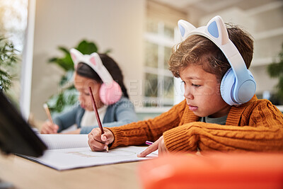 Buy stock photo Children, girl and boy with headphones, homework and writing in books for learning with audio. Siblings, education and notebook for development, problem solving and scholarship in family house