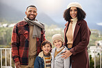 Portrait, children and happy family with winter fashion, travel and outdoor bonding on hotel balcony. Smile, parents and kids with love relationship, vacation and warm clothes for cold climate in USA