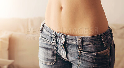 Buy stock photo Sexy, denim and stomach of woman in jeans for fitness, fashion and trendy style. Health, diet and abdomen with body of girl in pants for trend, edgy and stylish in living room of home