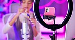 Makeup, girl and ring light for live streaming, beauty tutorial and review with online followers in neon bedroom. Influencer or content creator with phone and mascara, product or sponsorship at home