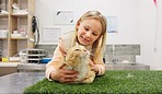 Child, cat and vet for checkup in clinic with love, care and medical exam for animal services of health. Smile, girl and kitten for healthcare, neutered surgery and assessment of veterinary support