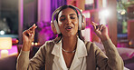 Headphones, Indian woman and night with singing, music and home with audio subscription. Neon, streaming and karaoke with happy, relax and track in a living room and listening to pop song on sofa