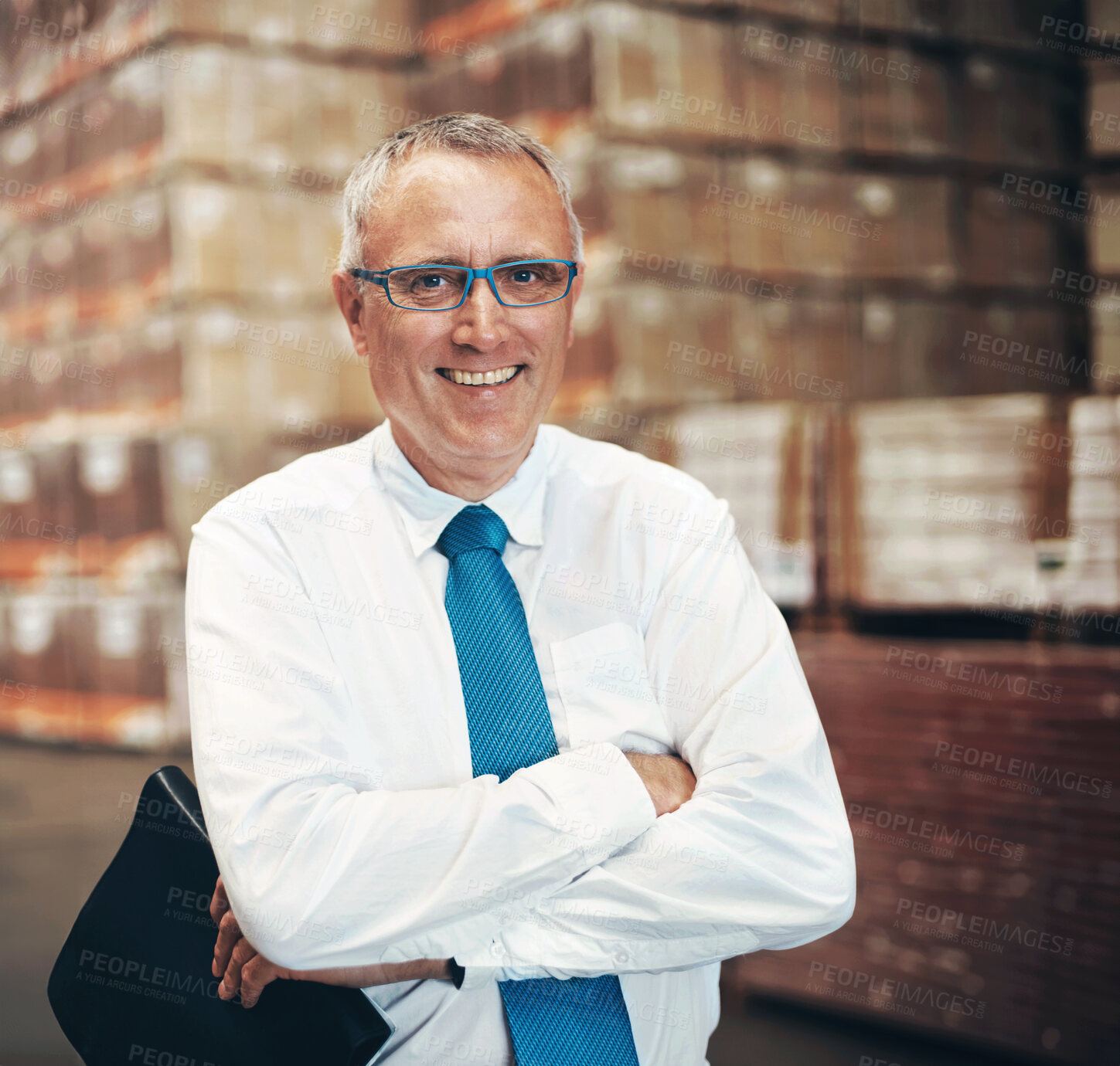 Buy stock photo Mature man, arms crossed and portrait at warehouse with smile, pride or career in supply chain management. Person, happy and job in logistics industry with cargo, distribution and storage in Portugal