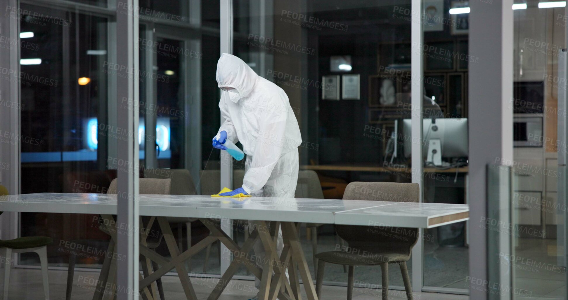 Buy stock photo Cleaner, person and cleaning table office for fumigation, spray disinfect and safety suit from disease risk in building. Maintenance, chemical liquid and pest control of healthcare, hygiene and virus