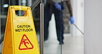 Caution, sign and cleaning for floor, janitor and hygiene service and dark at night in office. Mop, job and disinfection with equipment with warning and male person, disinfectant and wet ground