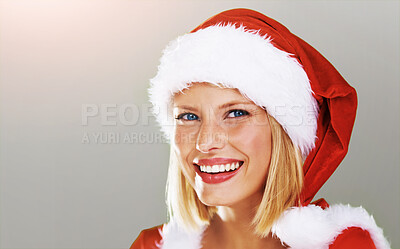 Buy stock photo Cute portrait of a happy young female modeling a red Father Christmas hat with white fur trim, isolated on green - copyspace