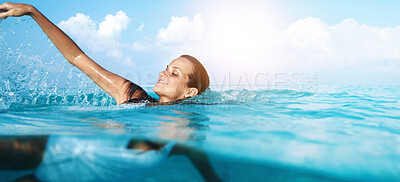 Buy stock photo Shot of a beautiful young woman swimming in blue ocean