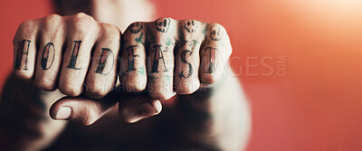 Buy stock photo Closeup shot of man showing the tattoos on his fingers against a red background