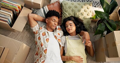 Buy stock photo Couple, above and resting on new home floor, mortgage and love for relationship or moving with boxes. People, property investment and together in apartment living room, care and homeowners sleeping
