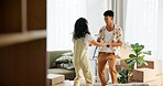 Happy couple, excited and moving house with boxes, new home and milestone in bonding together. Woman, man and lounge in apartment with marriage, support and dancing for pride, love and relationship