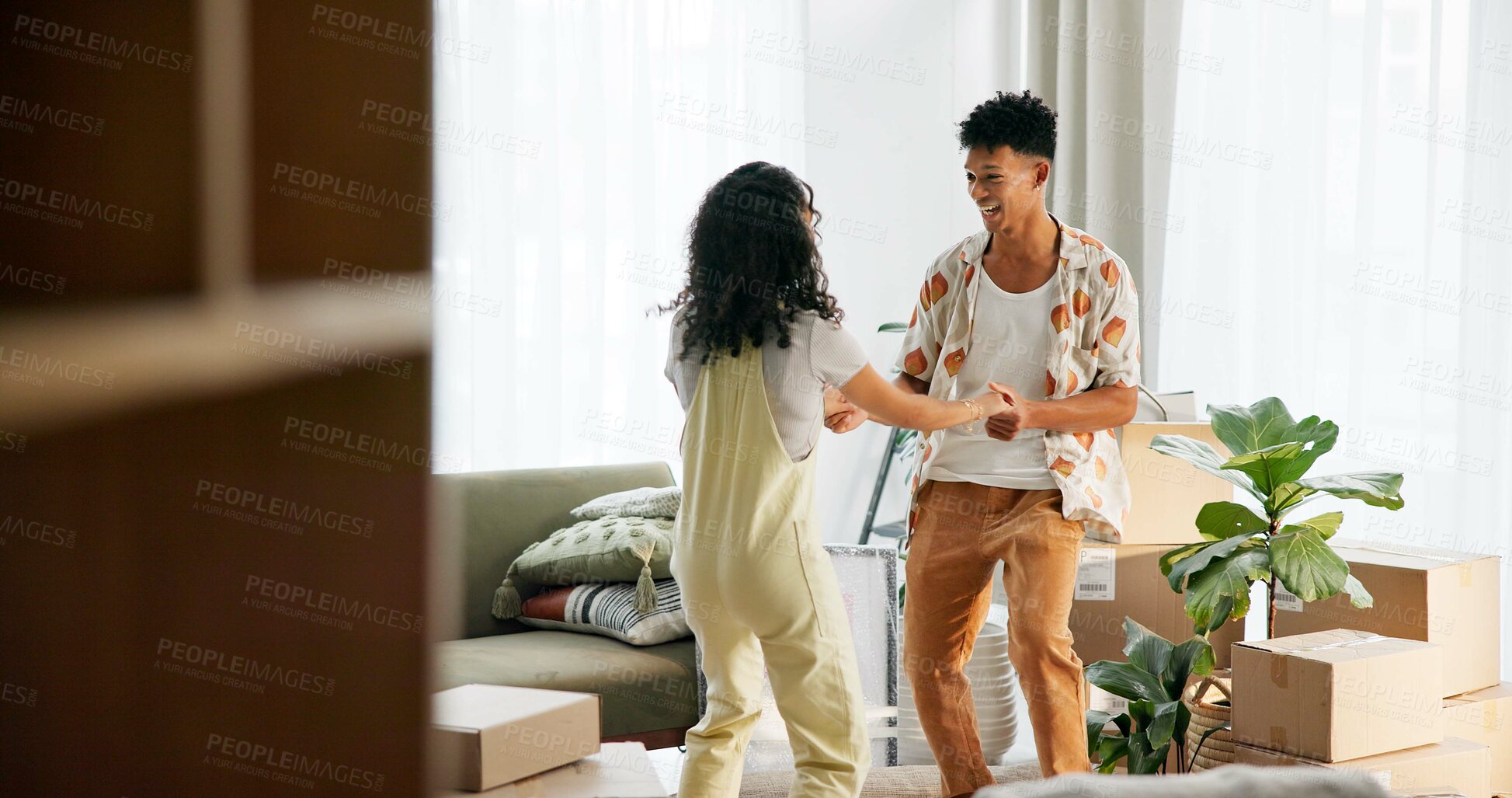 Buy stock photo Happy couple, excited and moving house with boxes, new home and milestone in bonding together. Woman, man and lounge in apartment with marriage, support and progress for pride, love and relationship