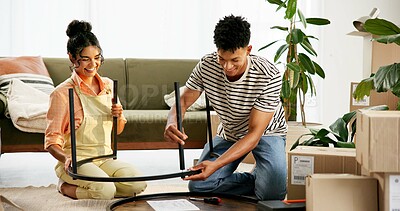 Buy stock photo Couple, people and happy with assemble table in new home with boxes for moving in. House, relationship and smile on teamwork or support for diy, furniture and ownership in living room for renovations