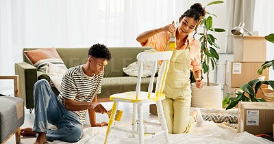 Buy stock photo New home, painting and couple in lounge, chair and teamwork with crafts, furniture and cooperation. Interior, apartment and man with woman, collaboration and relationship with boxes and real estate