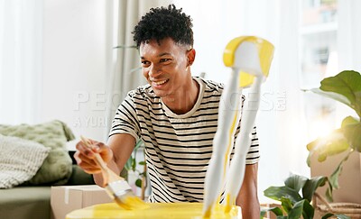 Buy stock photo DIY, chair and painting furniture with man in living room of home for creative, renovation or yellow. Art, handyman and painter with person in apartment for property or real estate maintenance