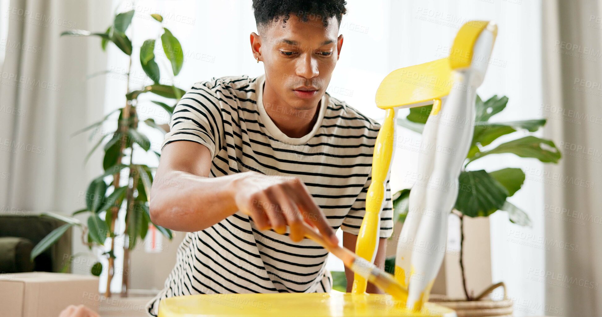 Buy stock photo DIY, chair and yellow with painter man in living room of apartment for creative renovation of furniture. Art, handyman and painting with person in apartment for property or real estate maintenance