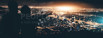 Buy stock photo Silhouette of a young couple enjoying the city nightscape